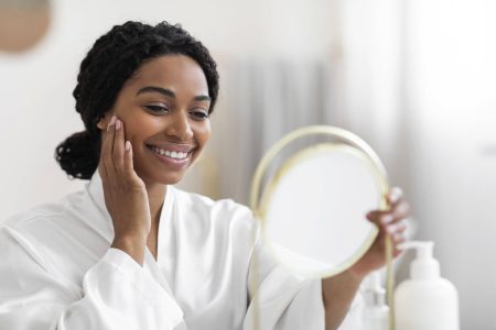 attractive-black-woman-looking-at-mirror-and-touch-2022-10-14-19-32-18-utc-min-2048x1365