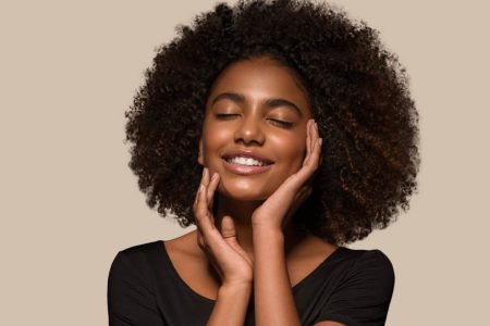 beautiful-african-woman-black-t-shirt-portrait-afro-haircut-touching-her-face-color-background-brown-min-1536x1152
